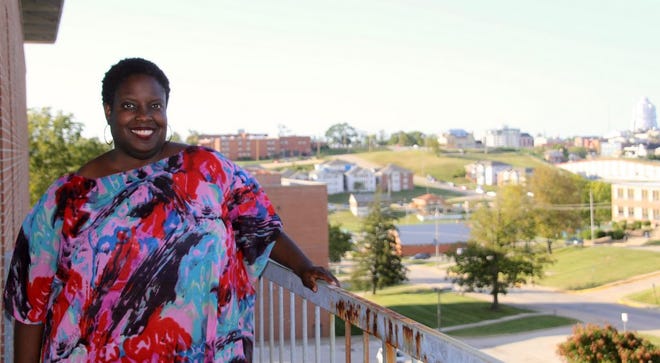 Ayanna Shivers stands on her balcony Sept. 26 at Lincoln University on Dunklin Street before the Jefferson City skyline.
