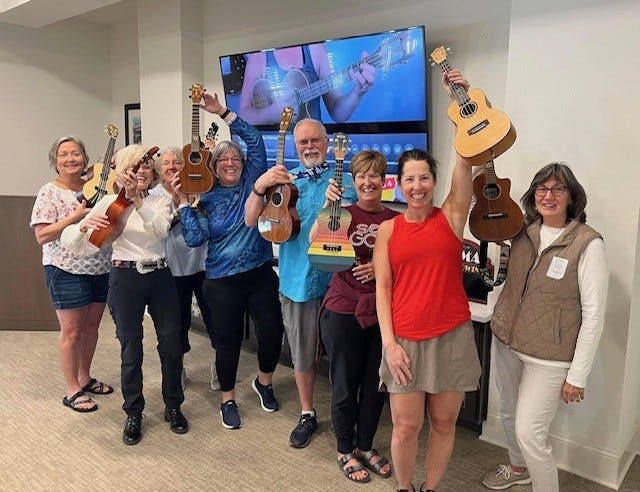 The Walton County Snowbird confident beginner ukulele group pose for a few photos.