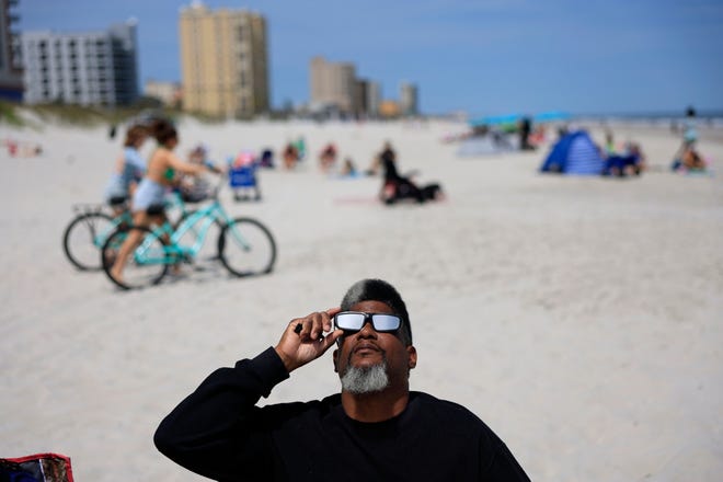 Eugene Hardeman of Jacksonville views the the start of the solar eclipse Monday, April 8, 2024 at Jacksonville Beach. According to Univision.com Jacksonville Beach experienced 63.8% totality.