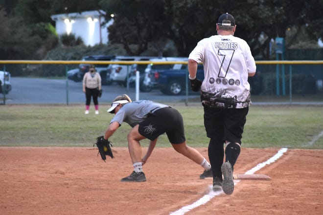Michelle Corrigan of My Destin Beach Vacation makes the catch at first to get Kurt Haynes of Reissue out. Corrigan had two hits for My Destin Beach. Reissue won the game 17-5.