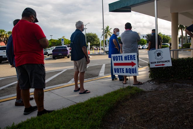 Community members stand in line to cast their vote during the first day of early voting, Monday, Oct. 19, 2020, at the Collier County Government Center in East Naples.