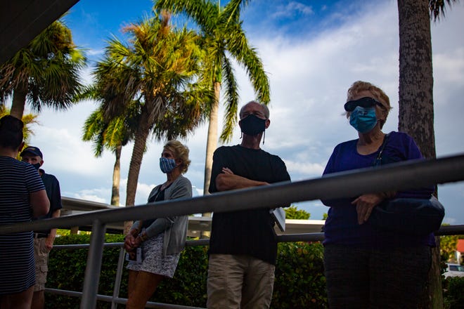 Community members wait for the doors to openat the Collier County Government Center in East Naples for early voting, Monday, morning,Oct. 19, 2020,