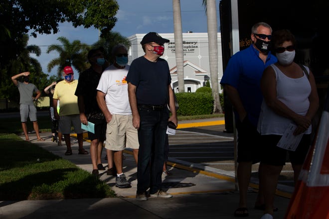 Community members stand in line to cast their votes during the first day of early voting, Monday, Oct. 19, 2020, in the Collier County Government Center in East Naples.