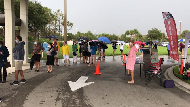 Voters at North Collier Regional Park battled the rain and long lines during the first day of early voting Oct. 19, 2020.