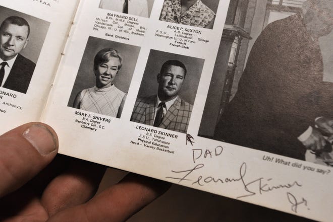 Charles Harding holds his copy of the 1969 Lee High School yearbook with faculty member Leonard Skinner ' s photograph Tuesday, May 8, 2018. Skinner was the namesake of the Lynyrd Skynyrd band.