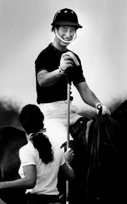 Prince Charles picks up his mallet before heading out to play in his first polo match in this photo from April, 4, 1980 in Wellington.